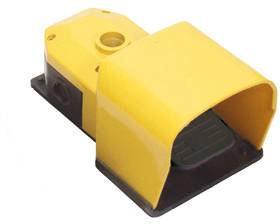 Pédale jaune avec protection, utilisée pour le contrôle des machines dans des environnements industriels.