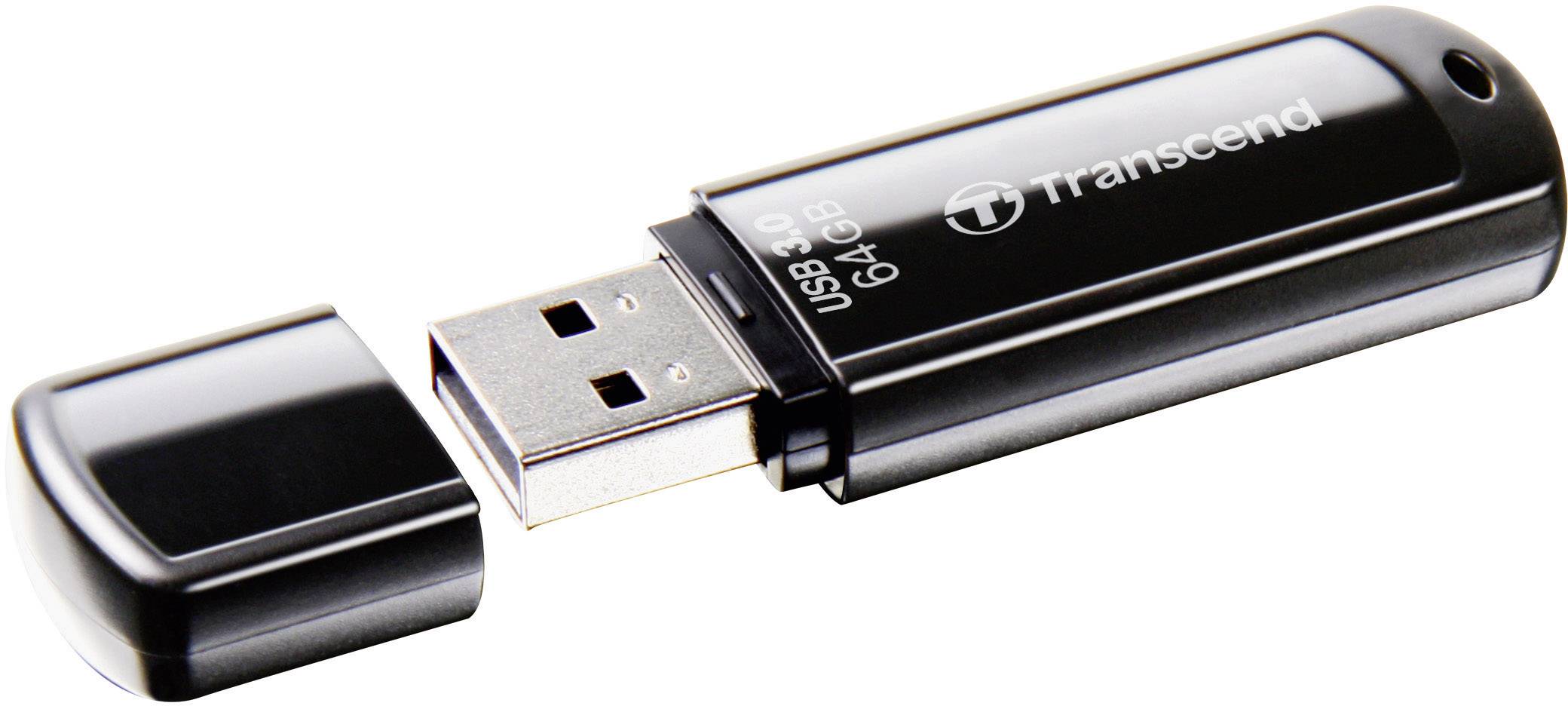 Une clé USB noire portant l'inscription '64 Go USB 3.0' de la marque 'Transcend'. Le capuchon est retiré et posé à côté.