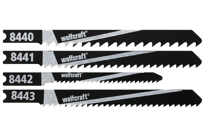 Quatre lames de scie sauteuse noires, chacune portant la marque 'wolfcraft' et les numéros 8440, 8441, 8442, 8443. Adaptées à différents matériaux.