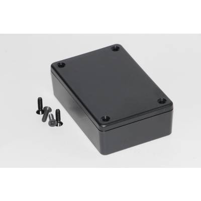 Un boîtier rectangulaire noir en plastique, probablement destiné à des composants électroniques, avec quatre vis noires à côté.