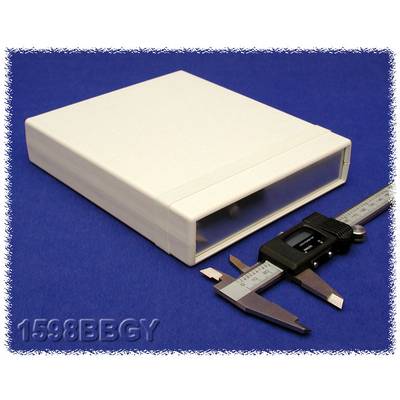 Un boîtier électronique blanc est posé sur un fond bleu. À côté se trouve un pied à coulisse pour déterminer les dimensions.