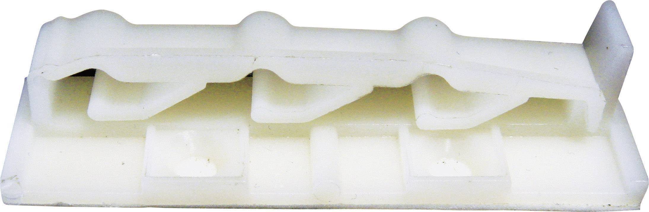 Une pièce en plastique blanc à plusieurs niveaux et cavités, probablement un élément technique ou un composant de connexion.