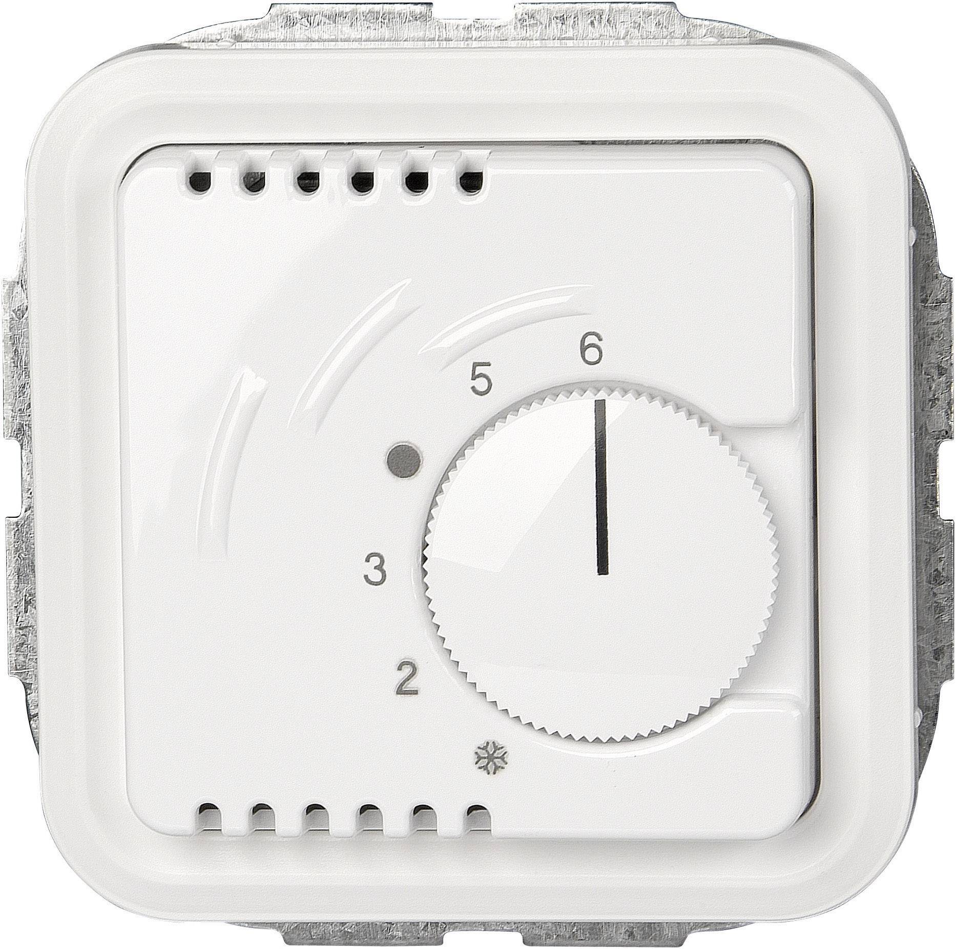 Un thermostat rotatif blanc avec une échelle de 0 à 6, monté dans un cadre métallique. Une flèche noire pointe sur le chiffre 6.