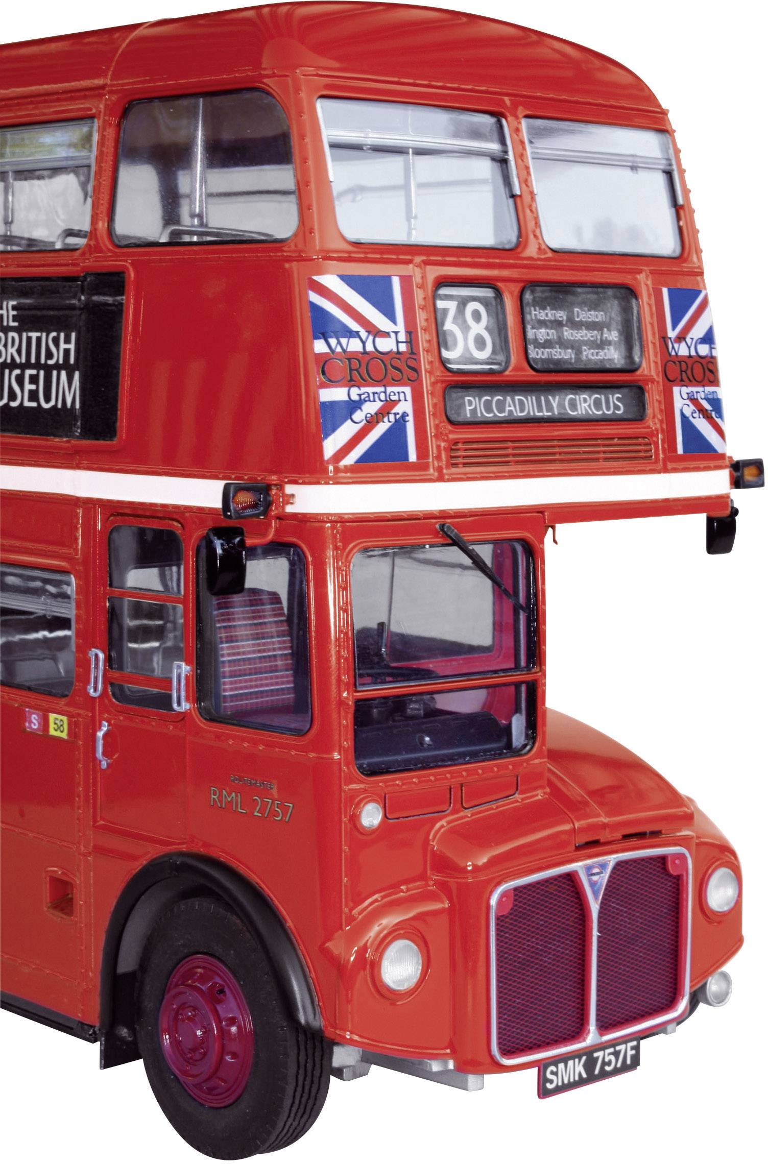 Bus rouge à deux étages avec l'inscription '38 Piccadilly Circus', drapeau britannique sur le côté, destination et détails affichés sur le panneau avant.