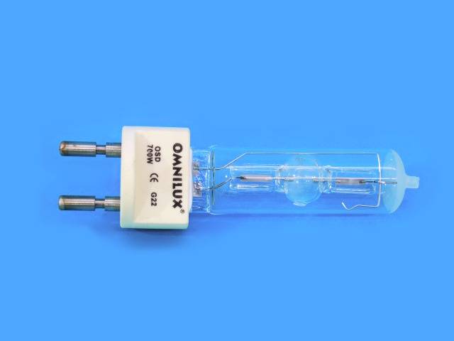 Ampoule électrique avec tube de verre cylindrique et deux broches métalliques à une extrémité, placée sur un fond bleu.