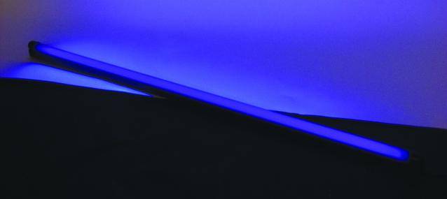 Un bandeau LED bleu lumineux sur un fond noir, créant une ambiance lumineuse futuriste.