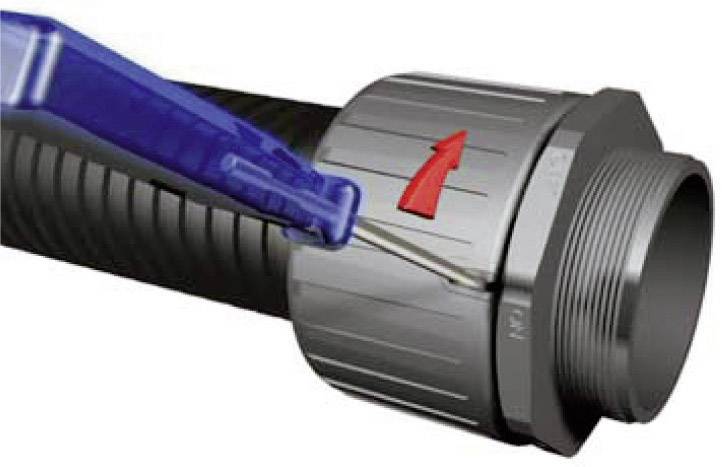 Un connecteur métallique de câble est desserré à l'aide d'un outil bleu. Une flèche rouge indique le sens de rotation.