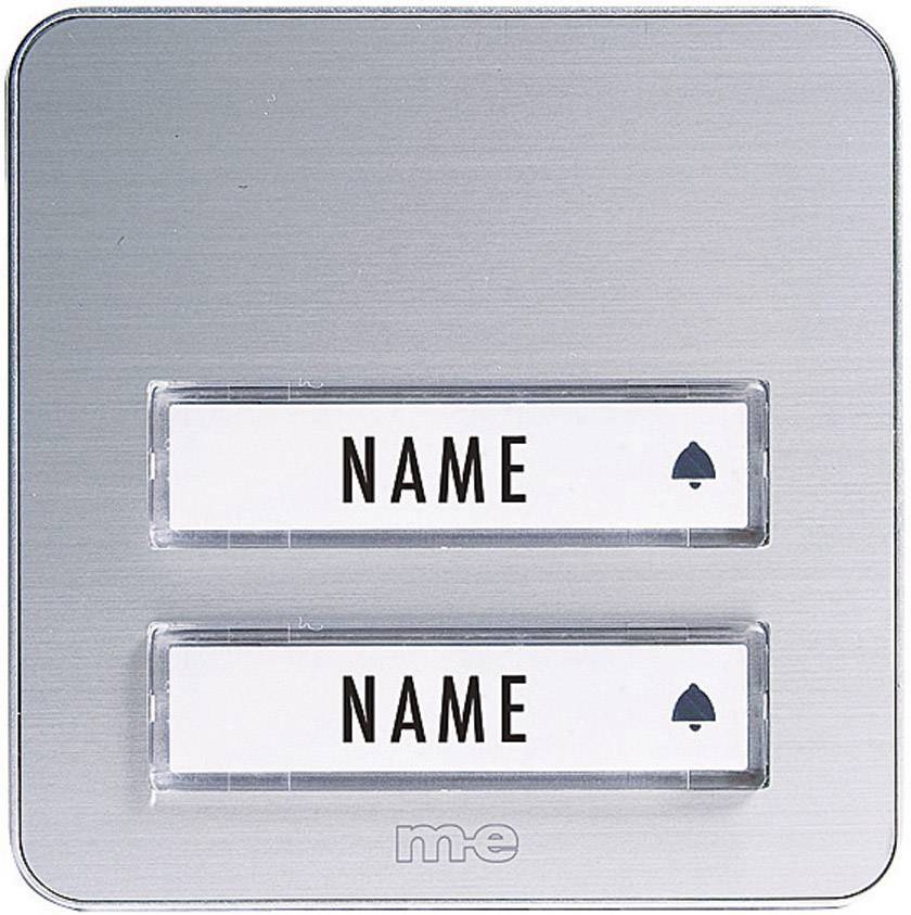 Deux plaques nominatives sur une plaque de sonnette métallique, chacune avec un texte d'espace réservé 'NOM', accompagnées chacune d'un petit symbole.
