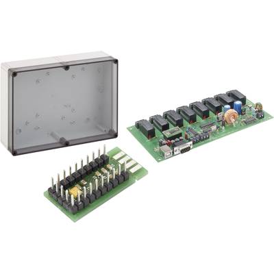 Boîtier électronique ouvert, montrant la carte de circuit imprimé avec des résistances, des condensateurs et des puces. À gauche, un boîtier vide.