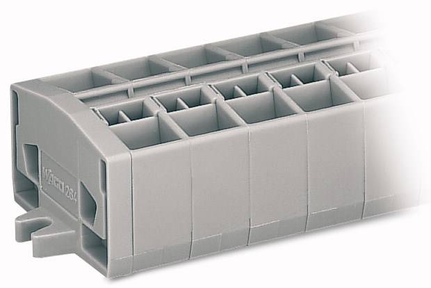 Un bloc gris en plastique avec de nombreuses chambres rectangulaires. Probablement un composant électrique ou une unité de connexion.