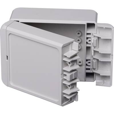 L'image montre un boîtier en plastique gris ouvert avec plusieurs passages de câbles et des possibilités de fixation à l'intérieur.