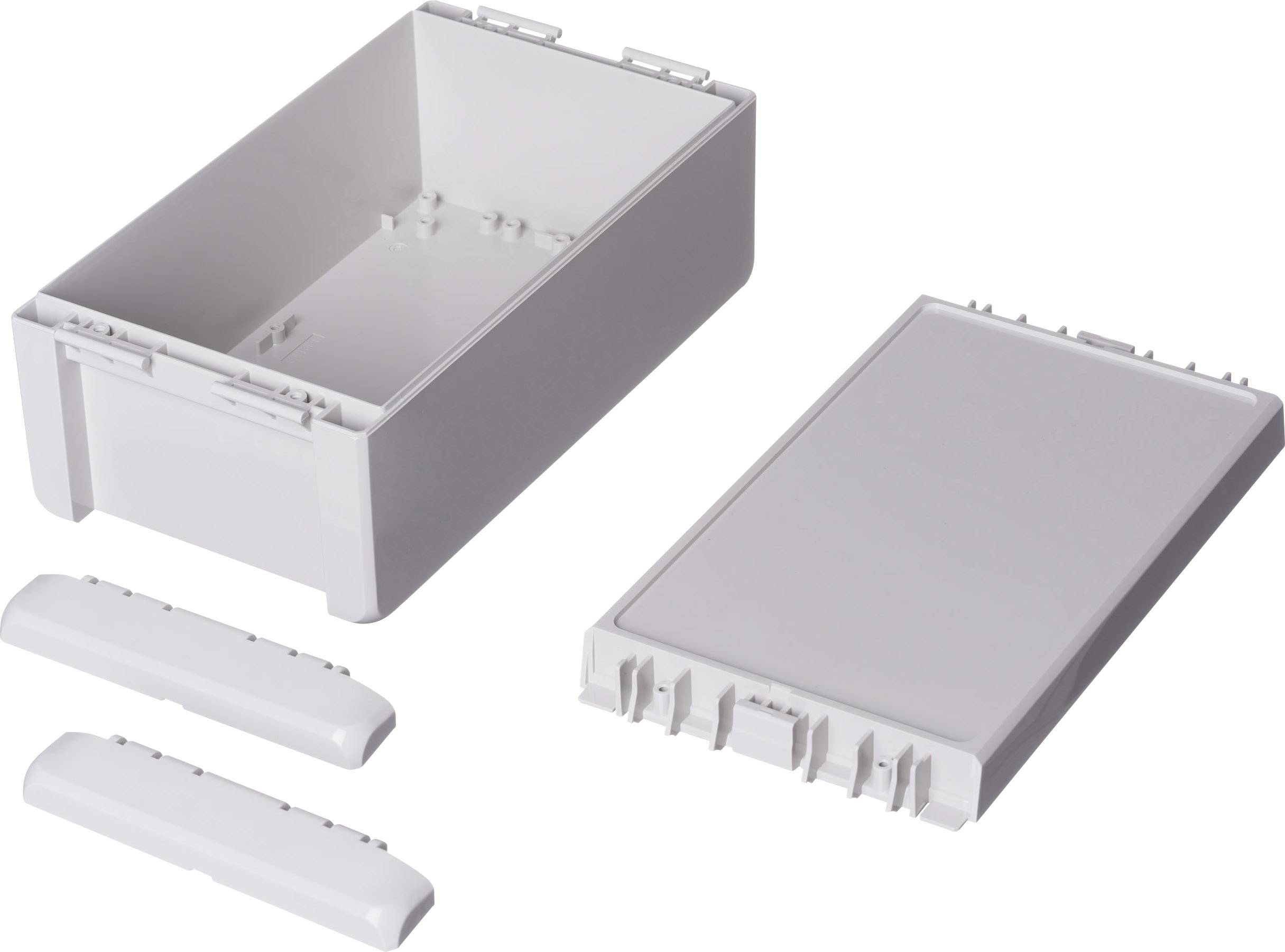Boîtier rectangulaire blanc en plastique composé de plusieurs pièces : base, couvercle et deux profilés de finition. Convient pour les composants électroniques.