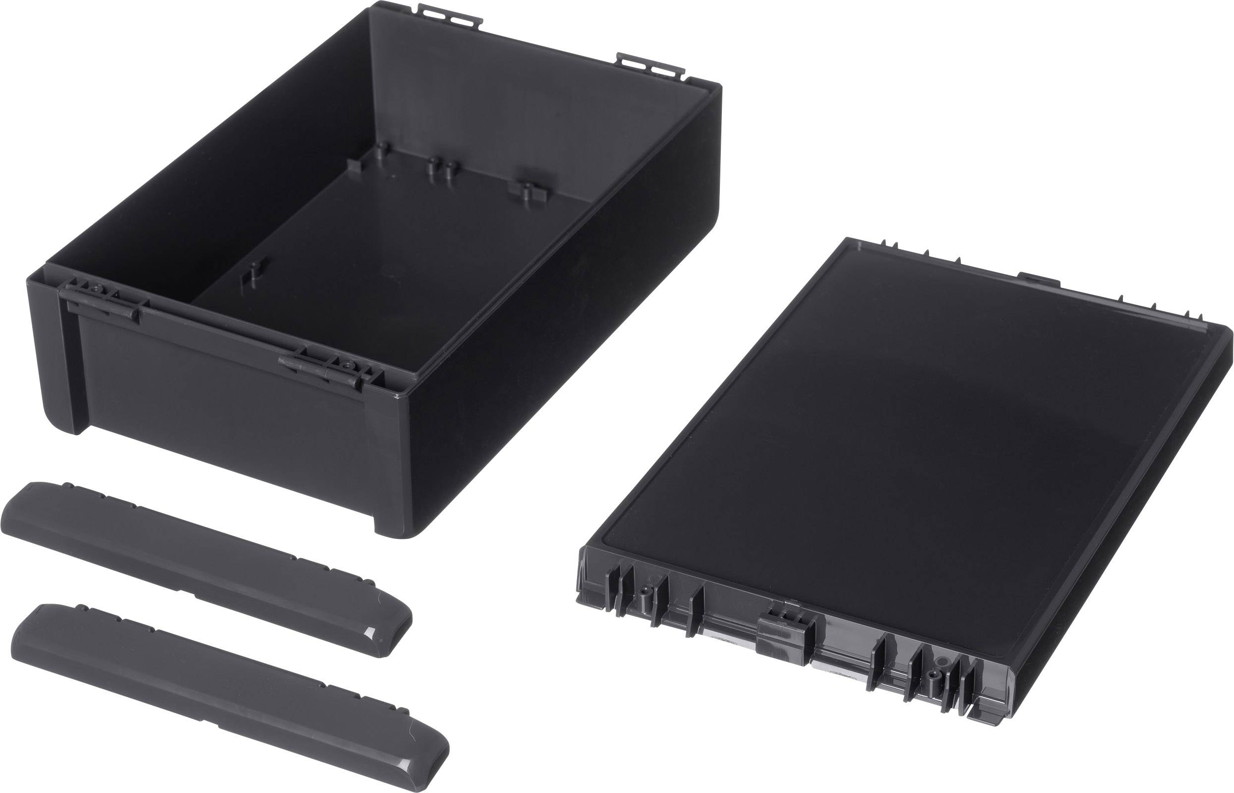 Ensemble d'accessoires en plastique noir composé d'un récipient rectangulaire, d'un couvercle et de deux pièces latérales, présenté sur un fond blanc.