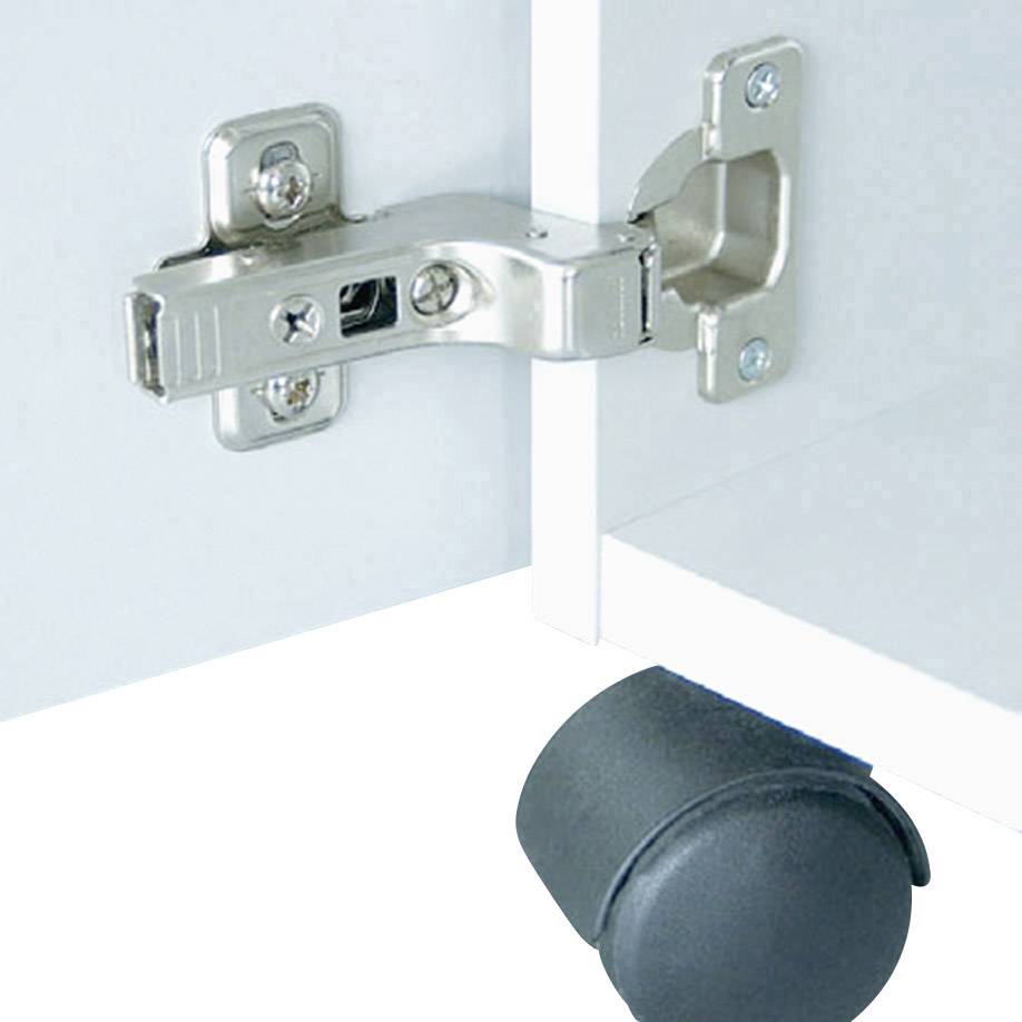 Gros plan d'une charnière de meuble installée dans une ouverture. Un rouleau de meuble noir est visible en dessous.