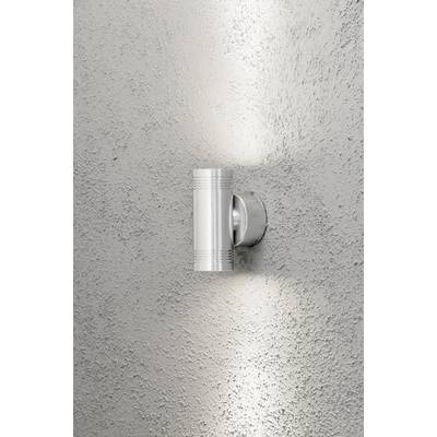 Une lampe murale moderne en argent qui diffuse de la lumière vers le haut et vers le bas sur un mur gris texturé.