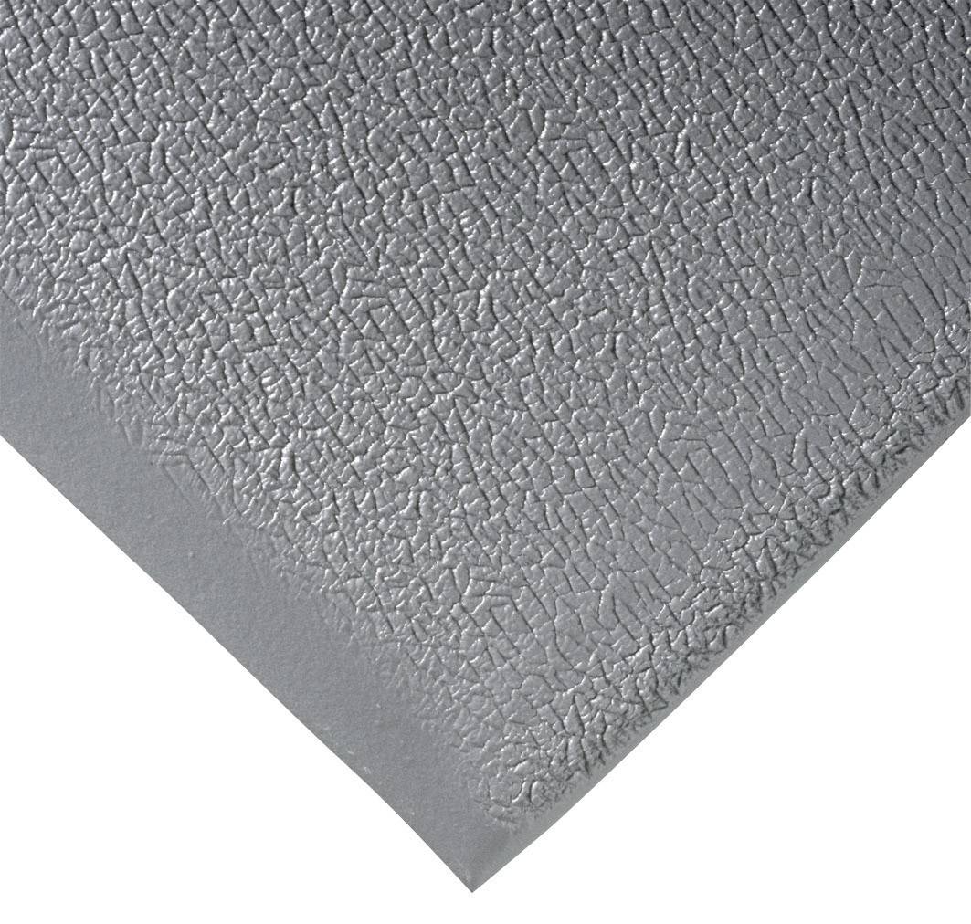 Un coin d'une surface gris argenté à la texture inégale et structurée.