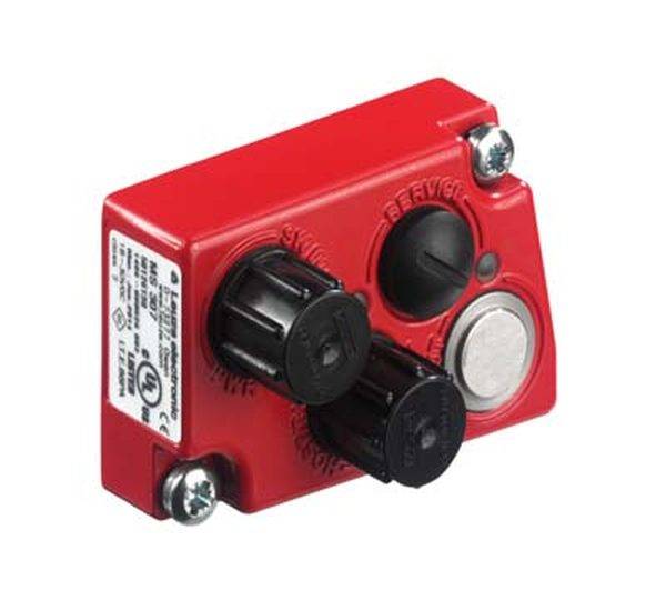 Un appareil électrique rouge et rectangulaire doté de deux boutons rotatifs noirs, d'un bouton noir et d'un interrupteur métallique, fixé avec des vis.