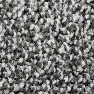 Gros plan sur un tapis gris texturé avec un motif ondulé.