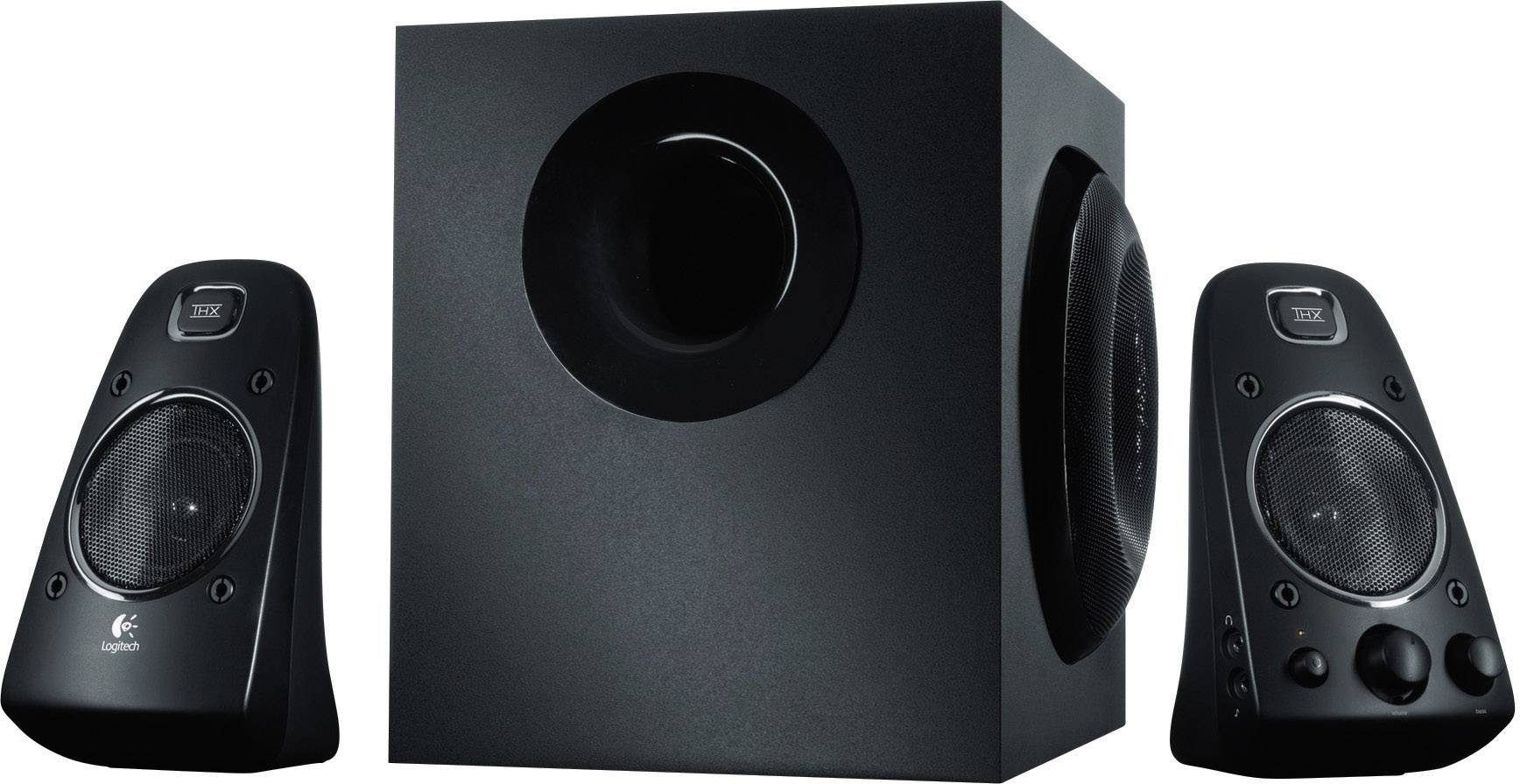 Deux enceintes noires et un caisson de basses au centre. Ces appareils sont adaptés aux systèmes audio domestiques et présentent un design moderne.
