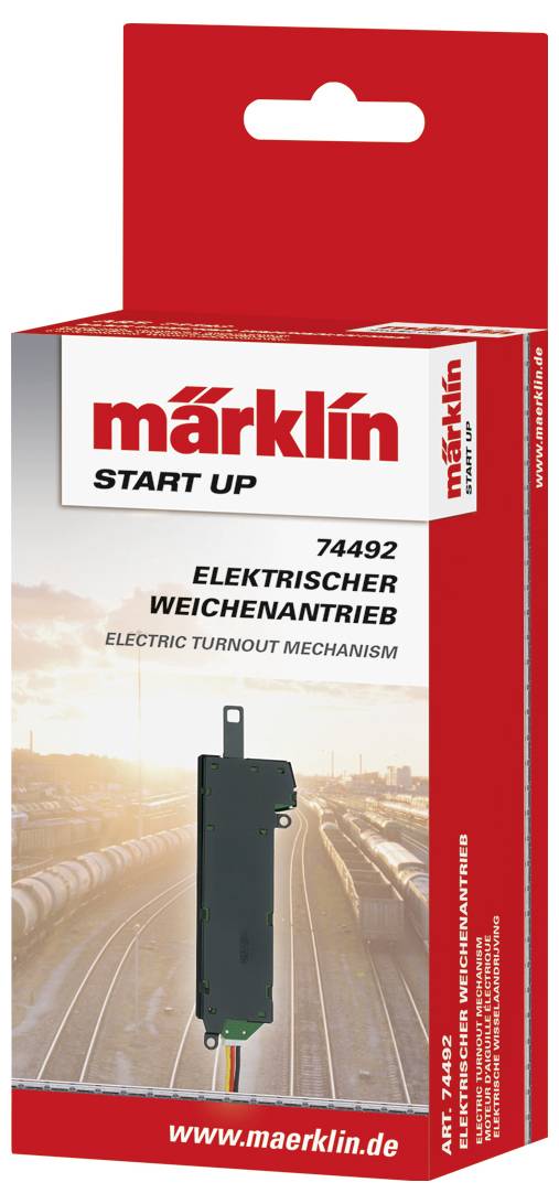 Pakiranje Märklin Start Up 'Električni upravljač skretnica' s prikazom mehanizma i željeznicom u pozadini. Broj artikla 74492.