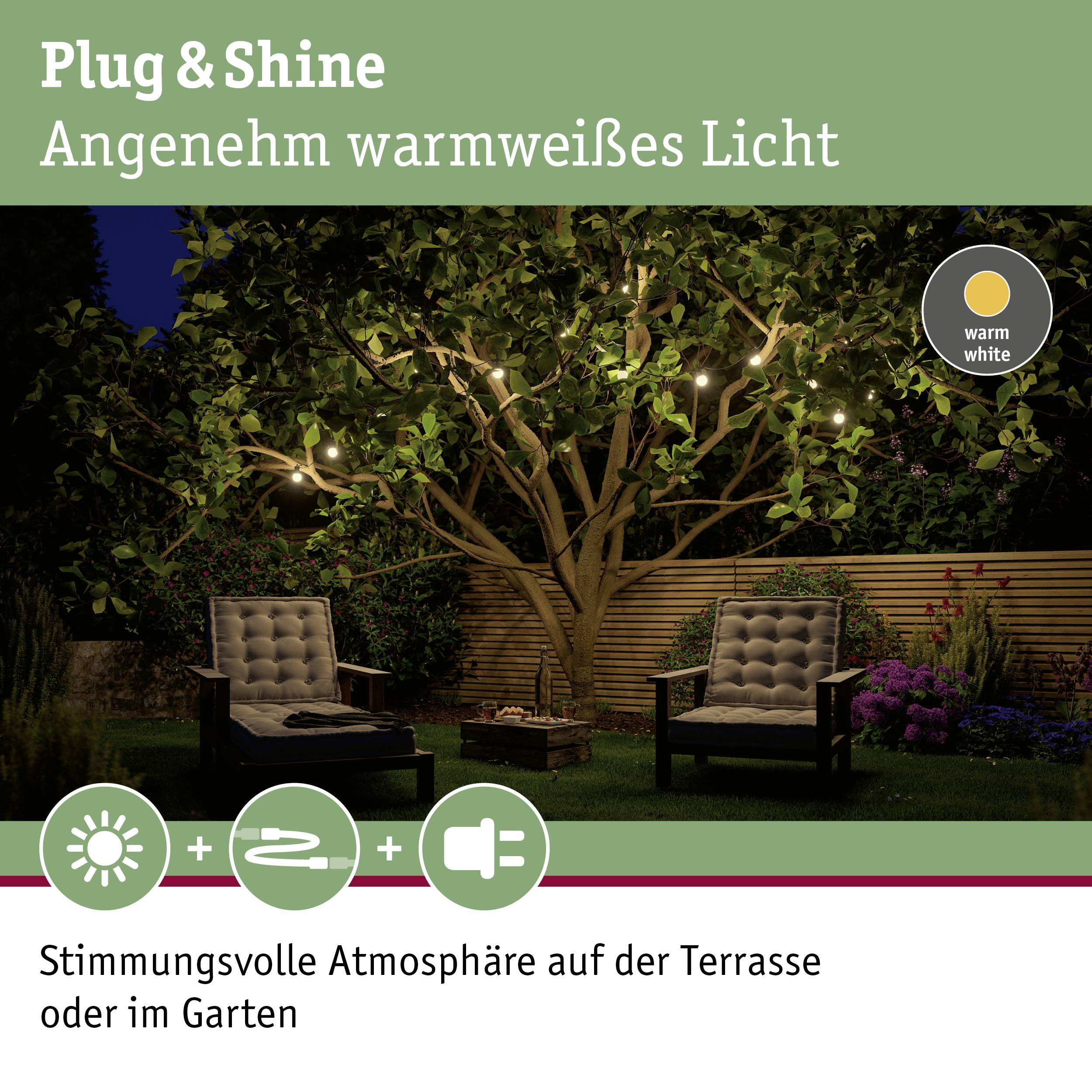 Plug & Shine rasvjeta s toplom bijelom bojom svjetla za terasu ili vrt, stvara ugodnu atmosferu; prikazuje osvjetljeno drvo.