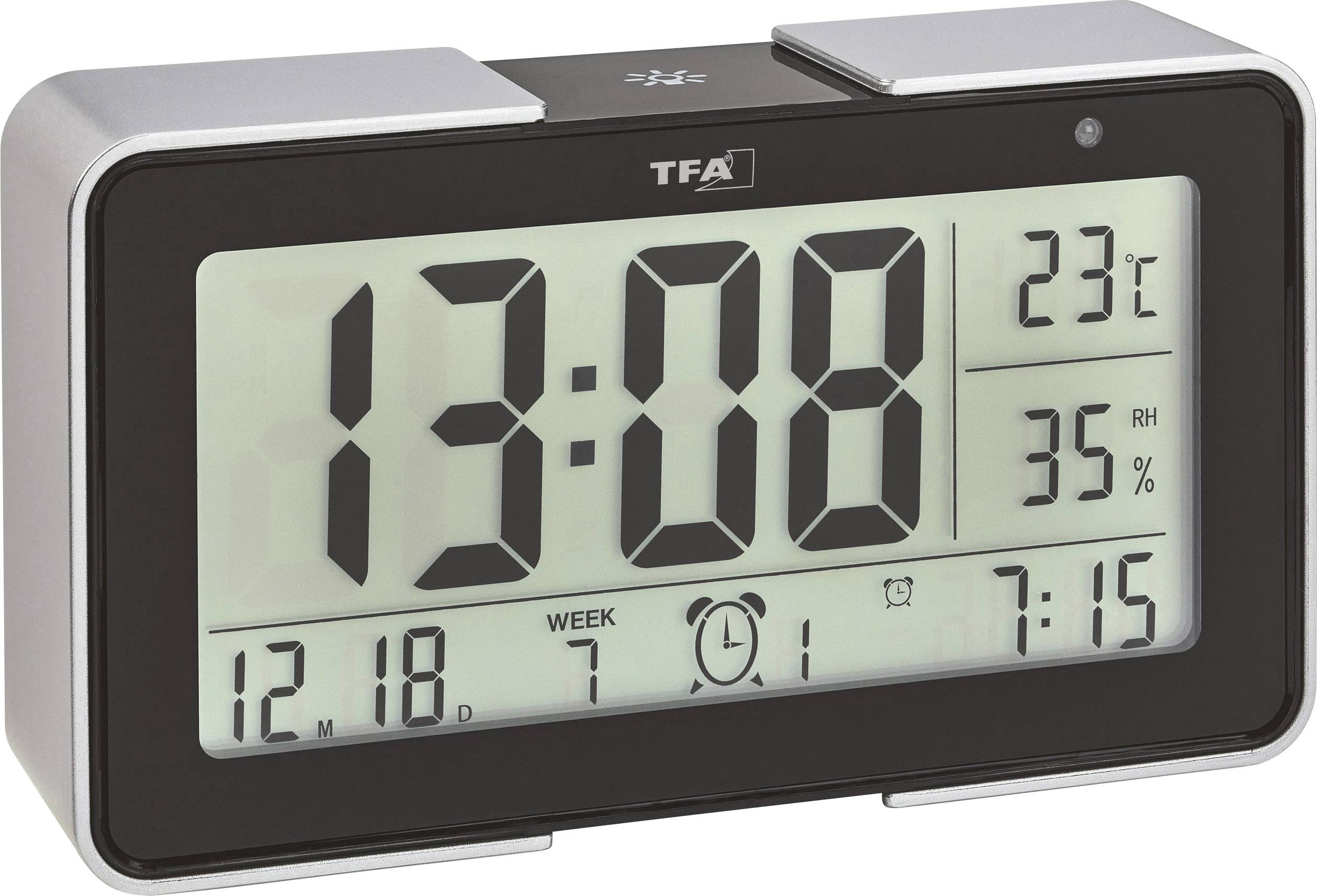 Elektronički sat s velikim zaslonom: vrijeme '13:08', temperatura '23°C', vlažnost zraka '35% RH', datum '12.18', alarm postavljen na '7:15'.