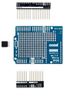 Plavi prototipni štit za Arduino s konektorima ipin headerima, postavljen za elektroničku montažu i programiranje.