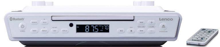 Bijeli radio za ugradnju s Bluetoothom i CDPlayerom. Na zaslonu prikazuje frekvenciju od 87,5 MHz. Pored njega se nalazi daljinski upravljač.