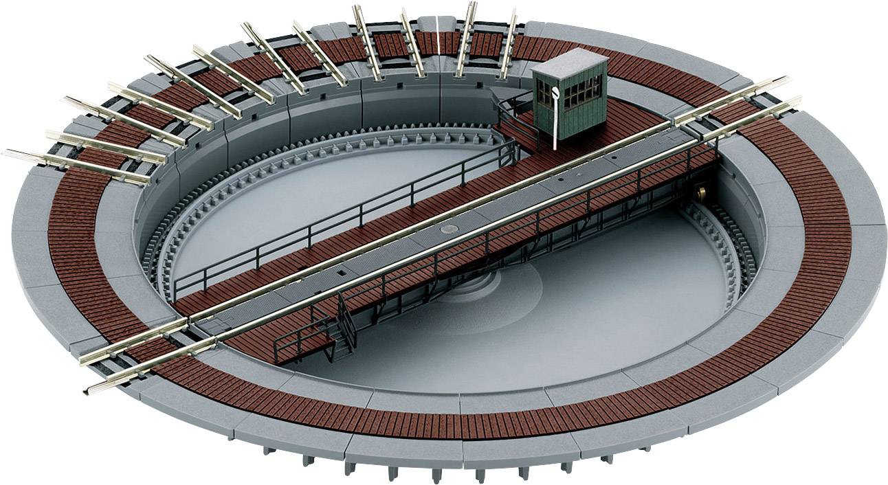 Model željezničke okretnice s crvenim i sivim prstenom tračnica, centralnim okretnim elementom i malenom zelenom kontrolnom kućicom na platformi.