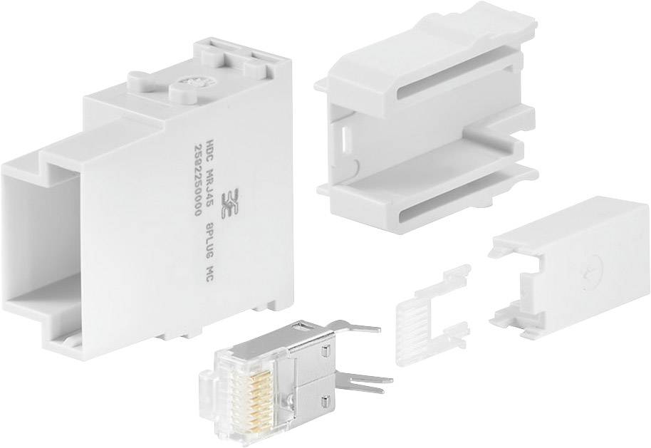 Višedijelni plastični adapter prikazan u pojedinačnim dijelovima. Kutni spoj sastavljen od utičnih elemenata i RJ45 modula.