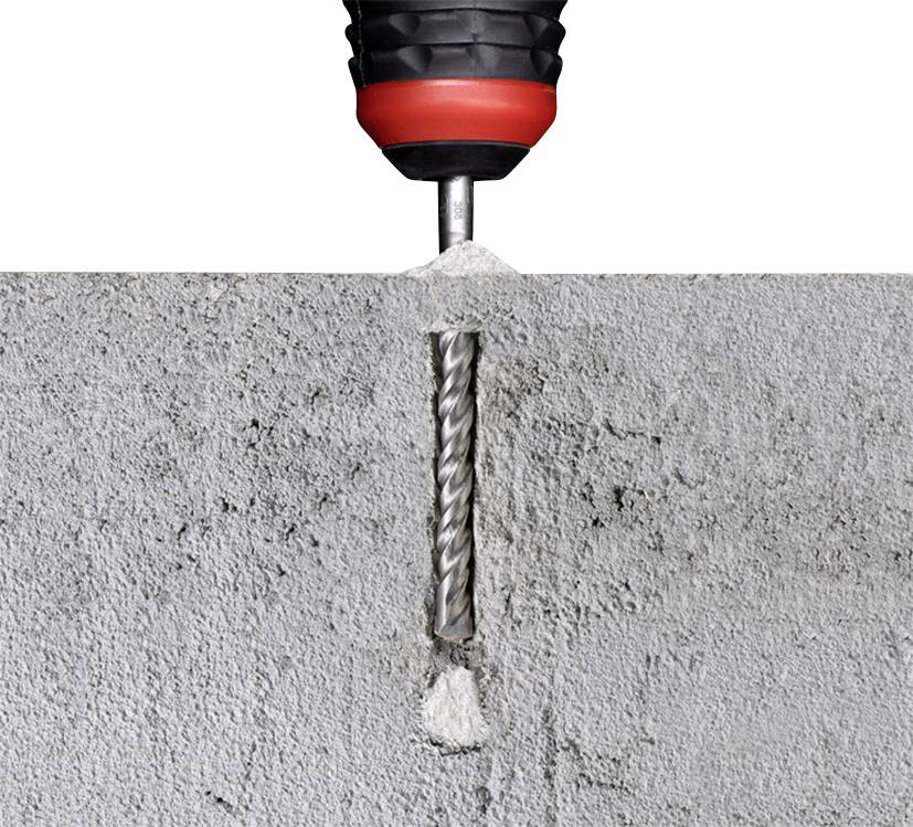 Bušač prodire okomito u betonski zid. Betonska prašina nakuplja se oko rupe, bušač je izrađen od metala i plastike.