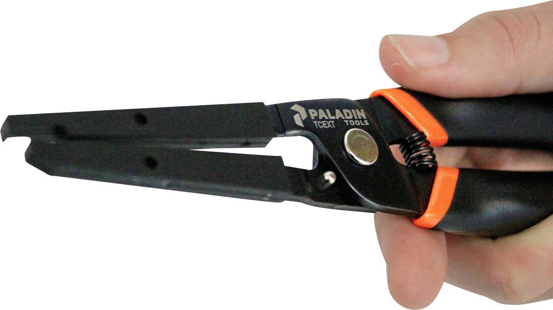 Jedna ruka drži crni skidač izolacije s narančastim akcentima. Alat je označen etiketom 'Paladin Tools'.