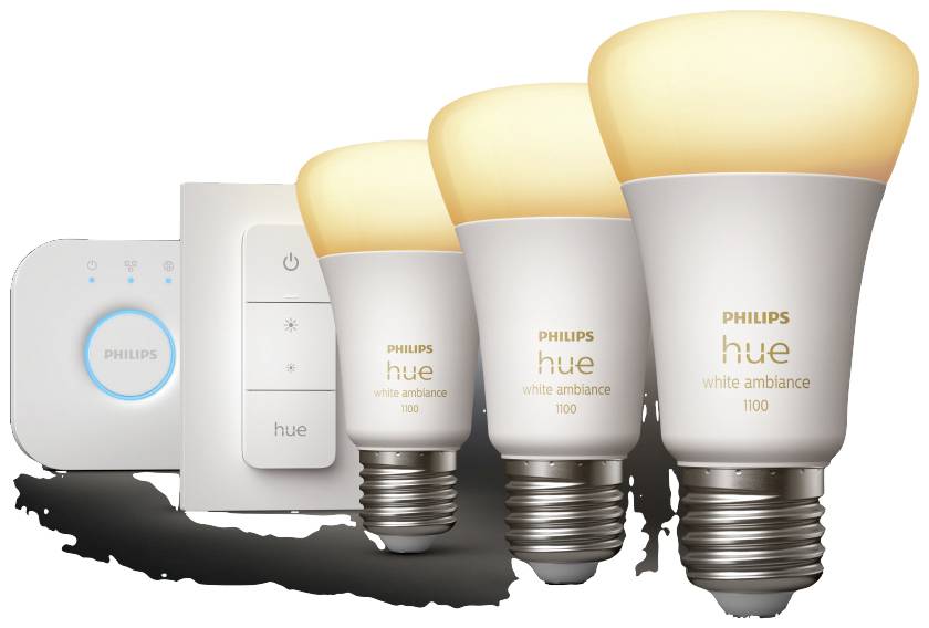 Tri sjajne Philips Hue žarulje bijele ambiente te jedinica za upravljanje. Žarulje su posložene u različitim veličinama.
