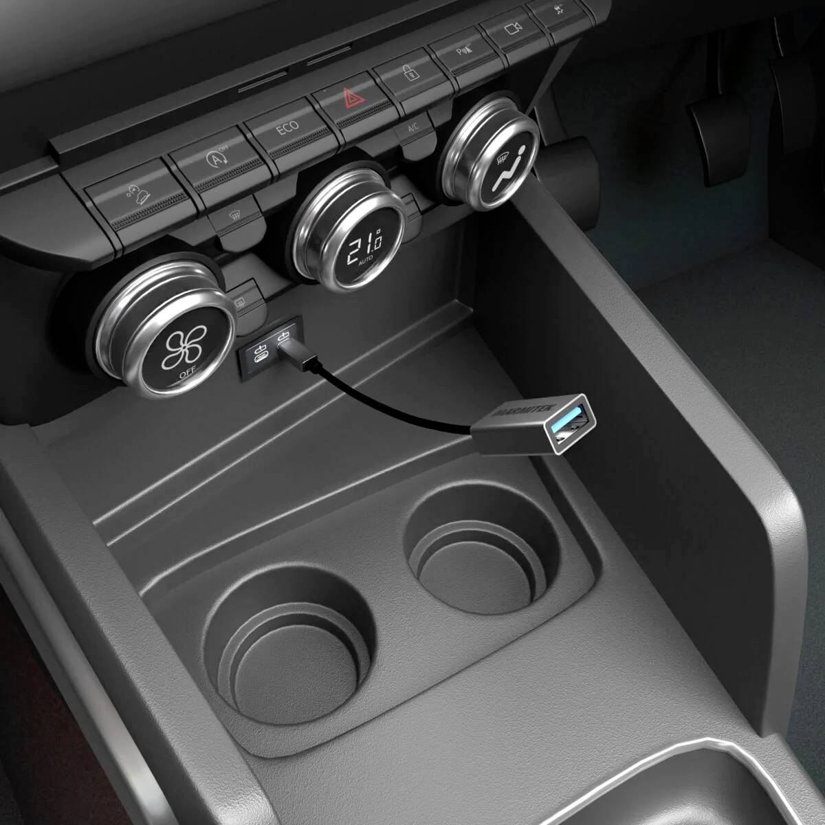 Srednja konzola automobila s okruglim ventilacijskim otvorima, USB priključkom i uključenim USB kabelom.
