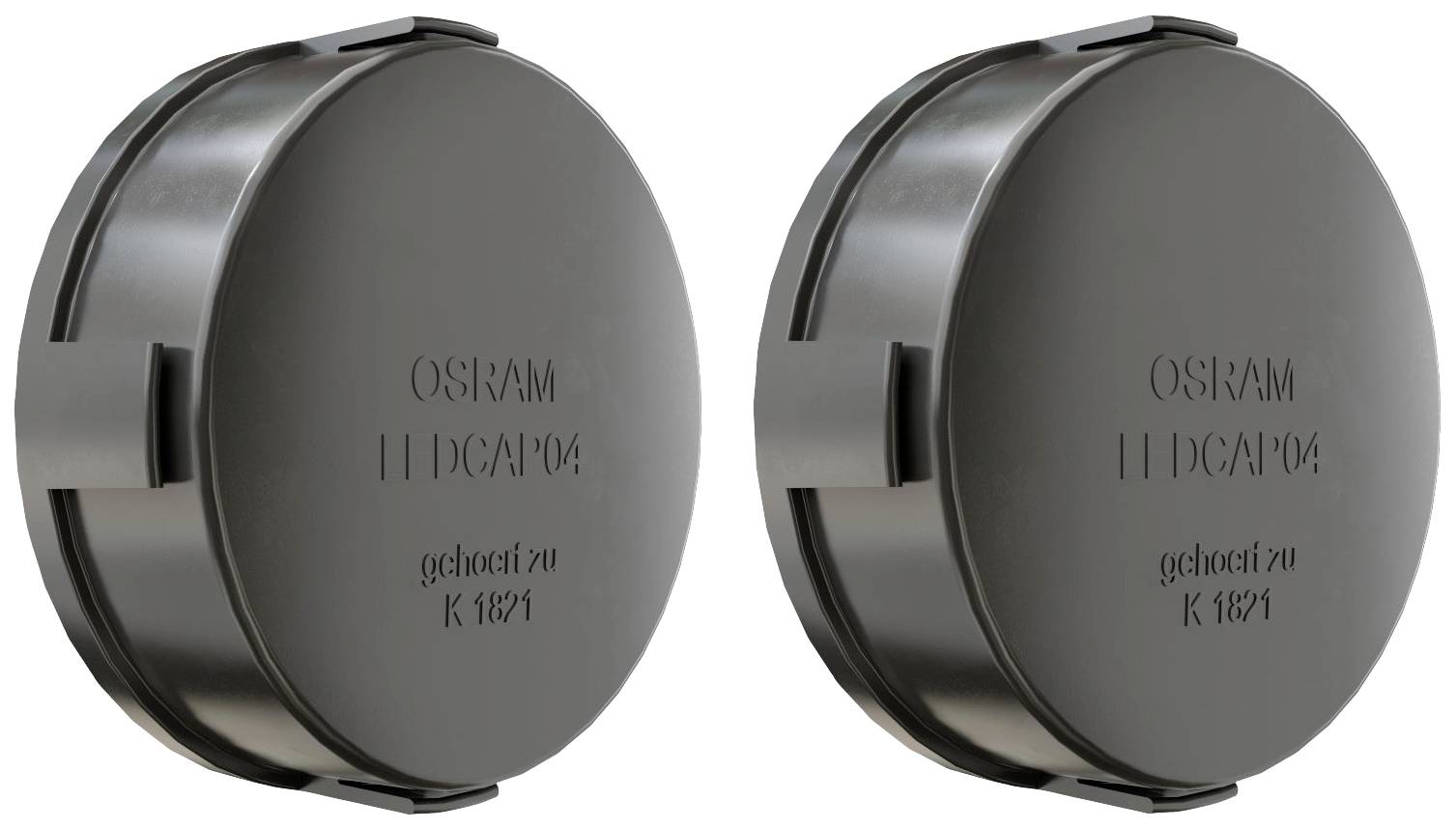 Dvije crne, okrugle LED kapice s natpisom 'OSRAM LED CAP 04' i 'gehorcht zu K 1871'. Postavljene su jedna do druge.