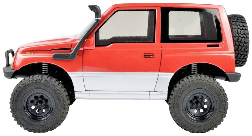 Crveno-bijelo igračka terensko vozilo s velikim off-road gumama, promatrano sa strane.