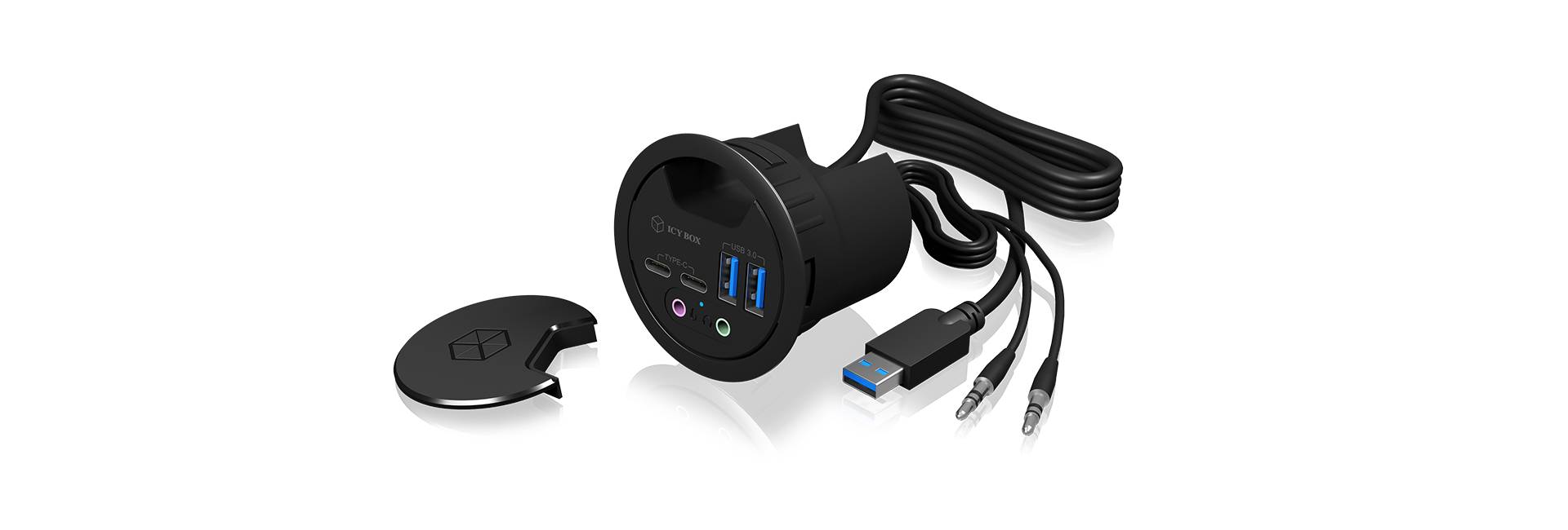 Okrugli stolni priključak s USB portom, audio ulazima i izlazima te uklonjivim poklopcem. Uključeni kabeli su USB i audio.