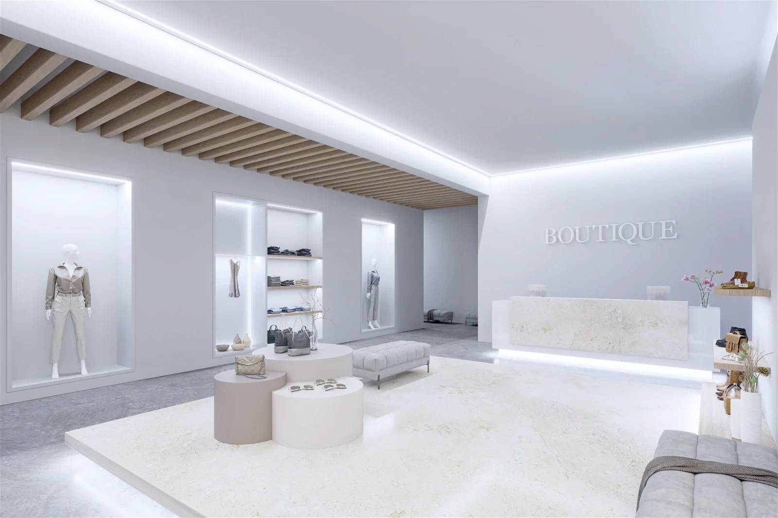 Moderan, minimalistički butik s osvjetljenim policama i recepcijskim pultom. Odjeća i dodaci su izloženi.