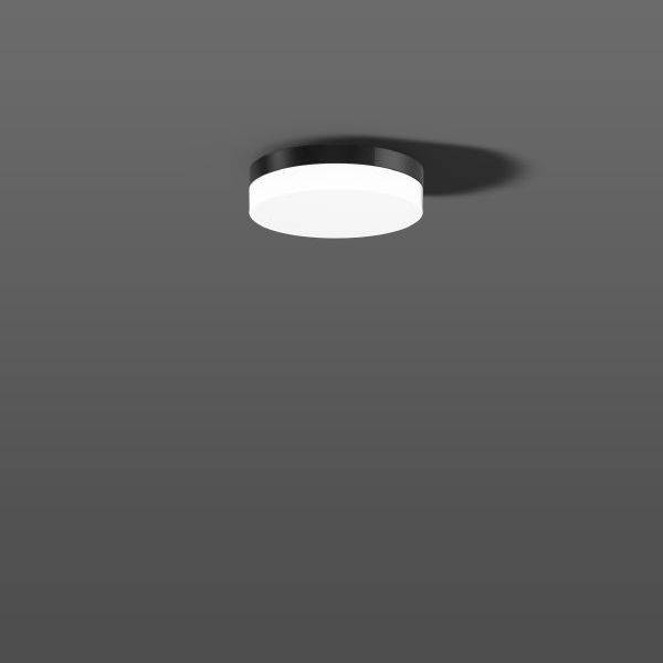 Okrugla stropna lampa na sivoj pozadini koja ravnomjerno odašilja meko svjetlo.