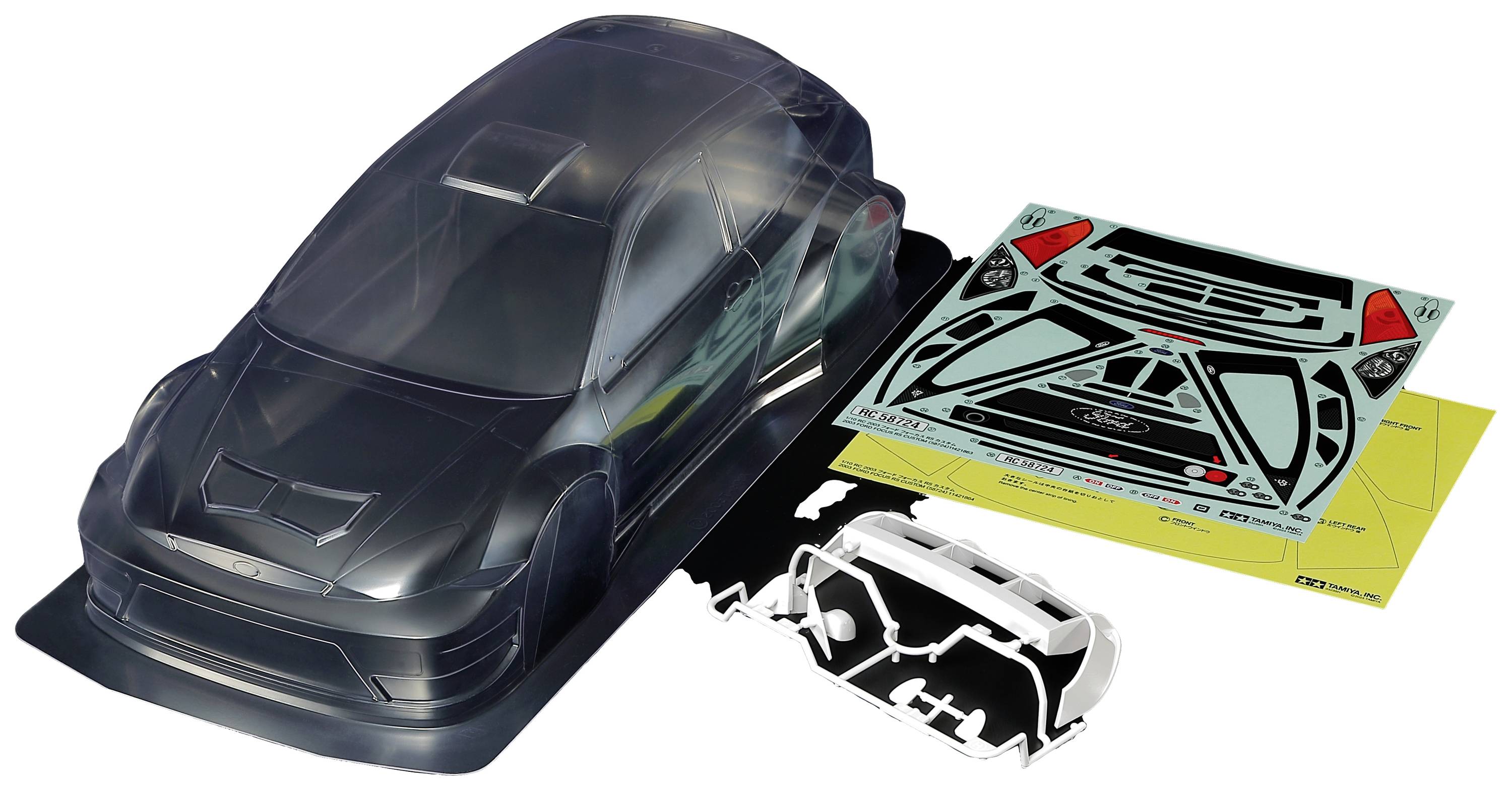 Prozirna karoserija modela automobila izrađena od plastike s dekorativnim folijama i sastavnim dijelovima za personalizaciju i montažu, prikazana na bijeloj pozadini.