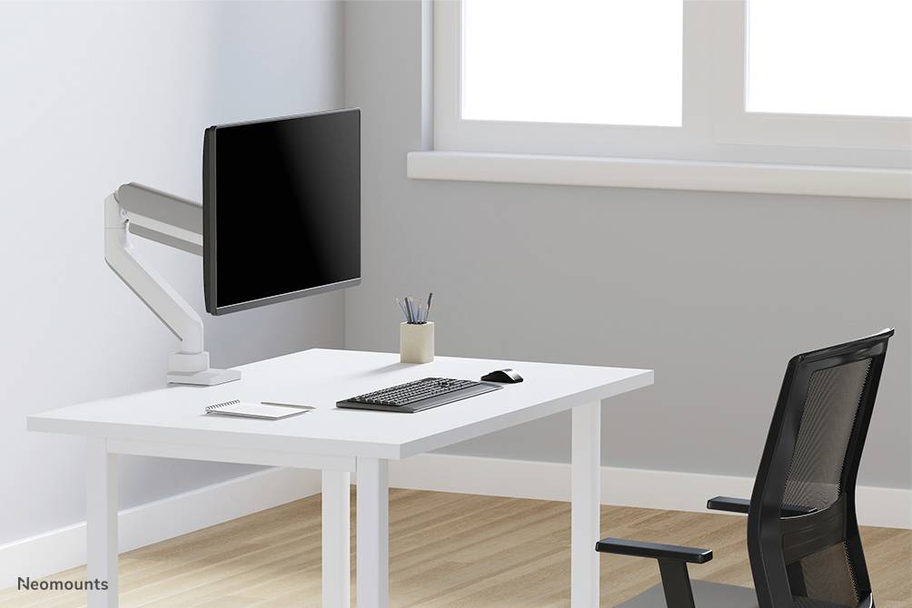 Minimalistički radni prostor s bijelim stolom, na kojemu se nalazi monitor na zglobnoj ruci, tipkovnica, miš, držač olovaka; crna stolica.