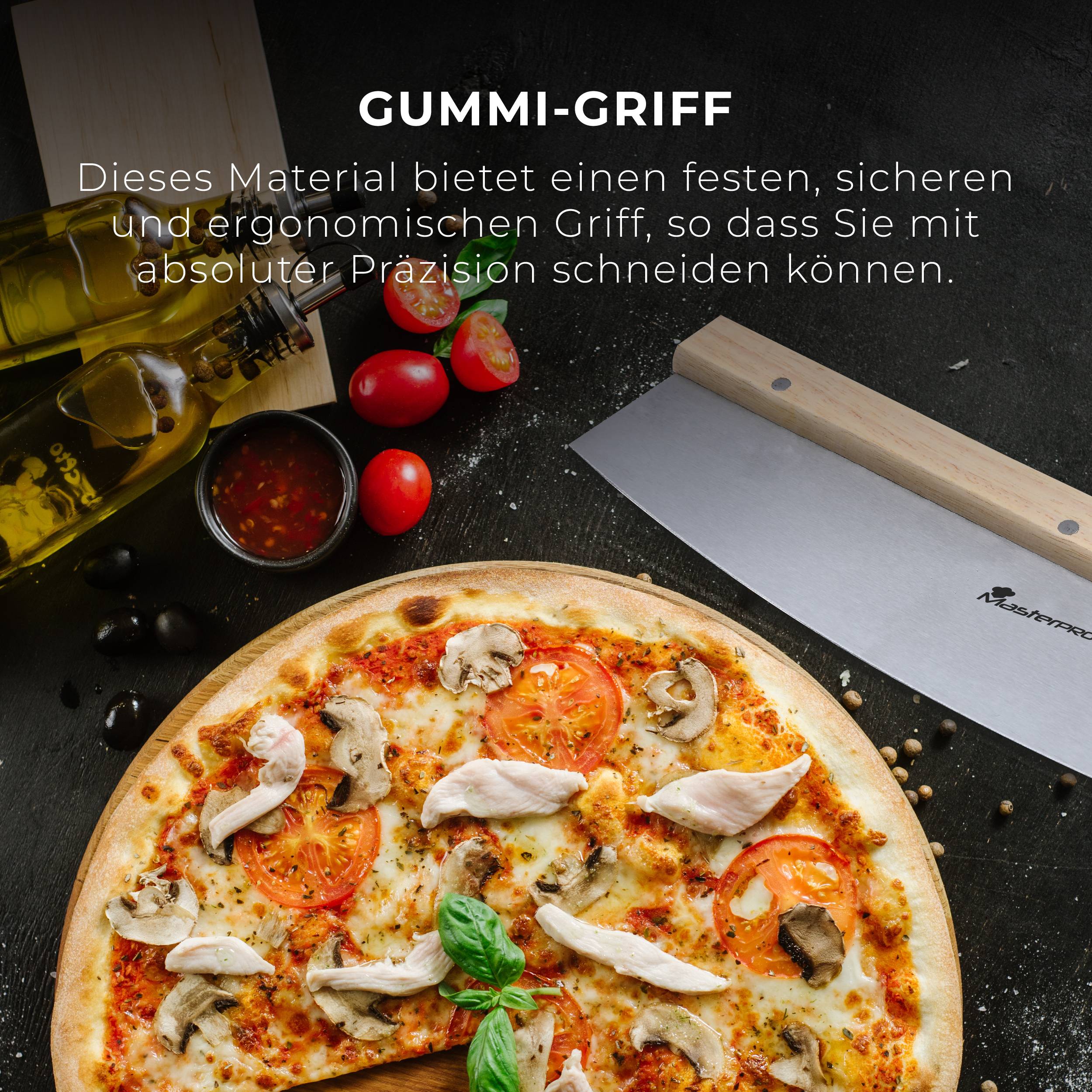 Pizza na drvenom dasci, velika oštrica noža pored. Tekst gore: 'Gumeni ručak'. Sastojci: maslinovo ulje, rajčice, papar u zrnju.
