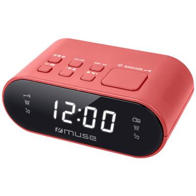 Crveni sat za buđenje pokazuje '12:00' na digitalnom zaslonu. Na vrhu se nalaze nekoliko upravljačkih tipki, uključujući tipku za odgodu buđenja (snooze).