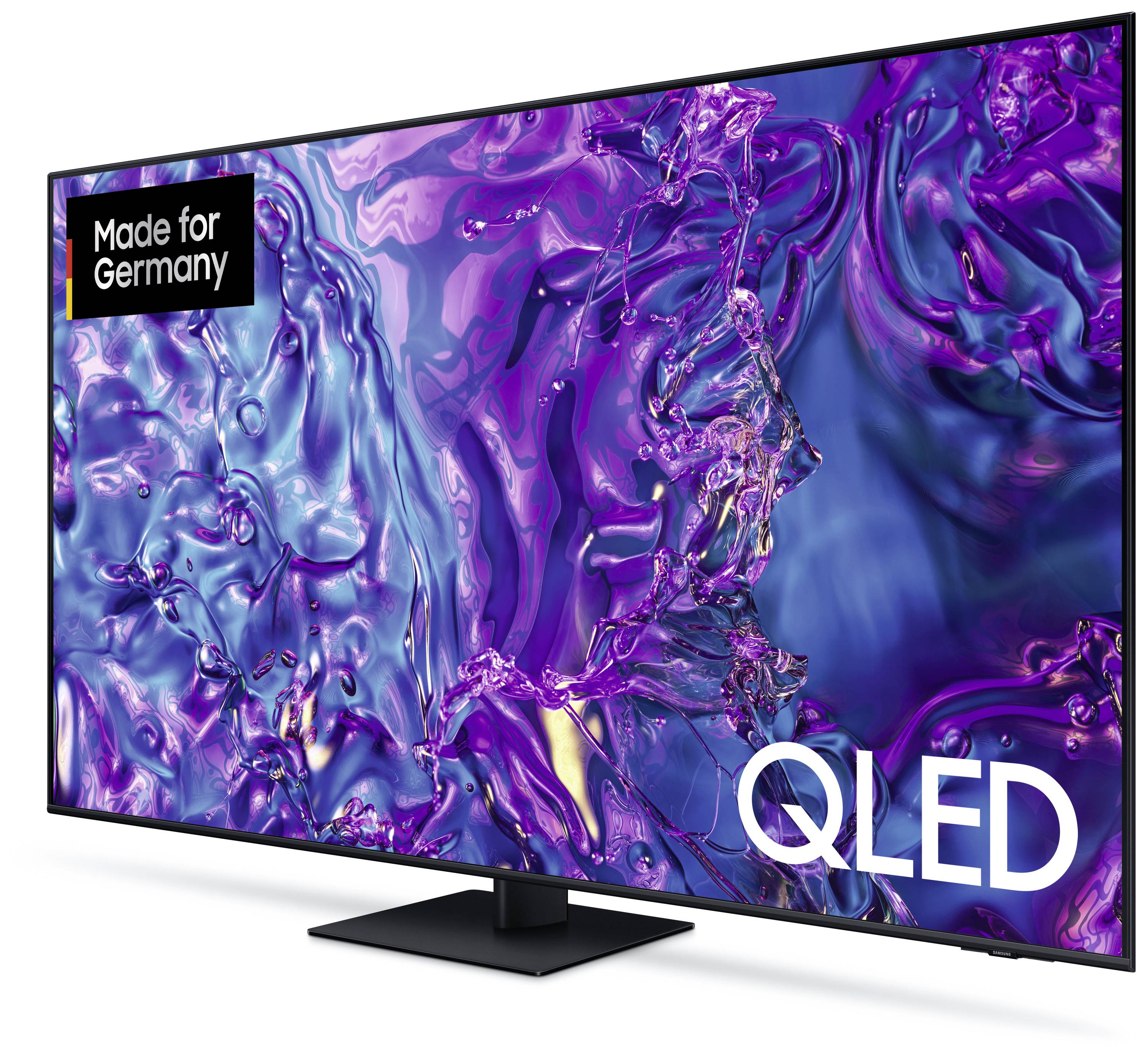 QLED televizor s velikim zaslonom prikazuje apstraktne, šarene uzorke u ljubičastim i plavim tonovima. Natpis: 'Napravljeno za Njemačku'.