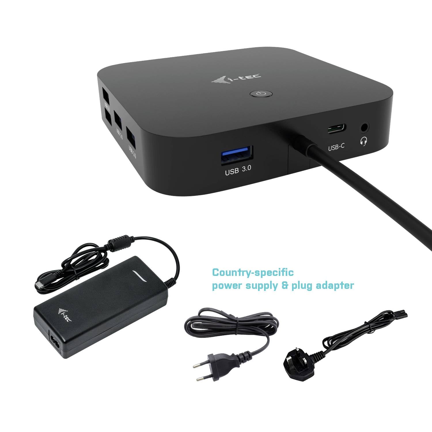 Crni, pravokutni USB razvodnik s više priključaka leži pored napajanja i mrežnog adaptera.