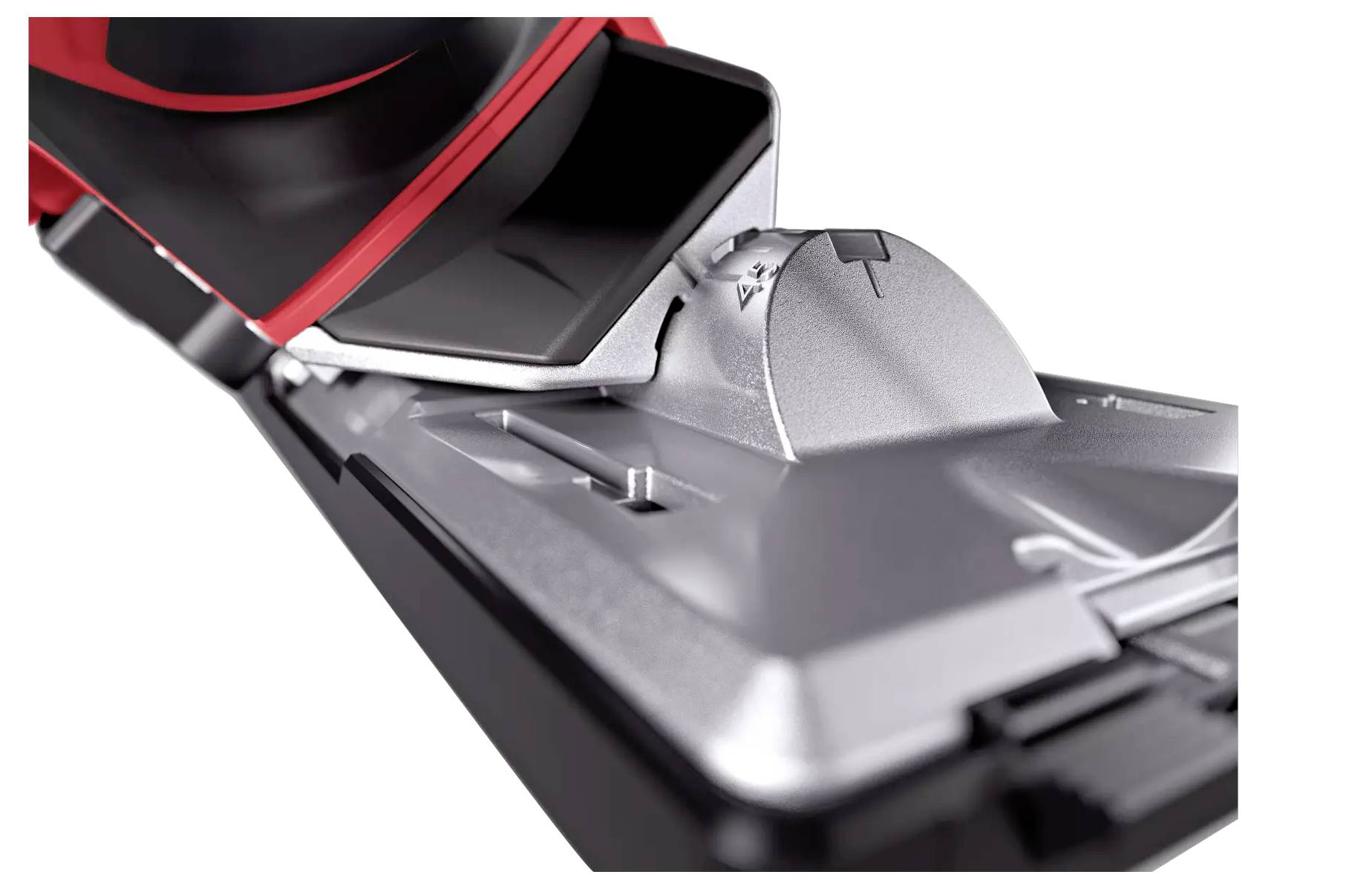 Bliski plan glave usisavača s četkom i metalnim poklopcem. Fokus na tehnologiji i funkcionalnosti uređaja.