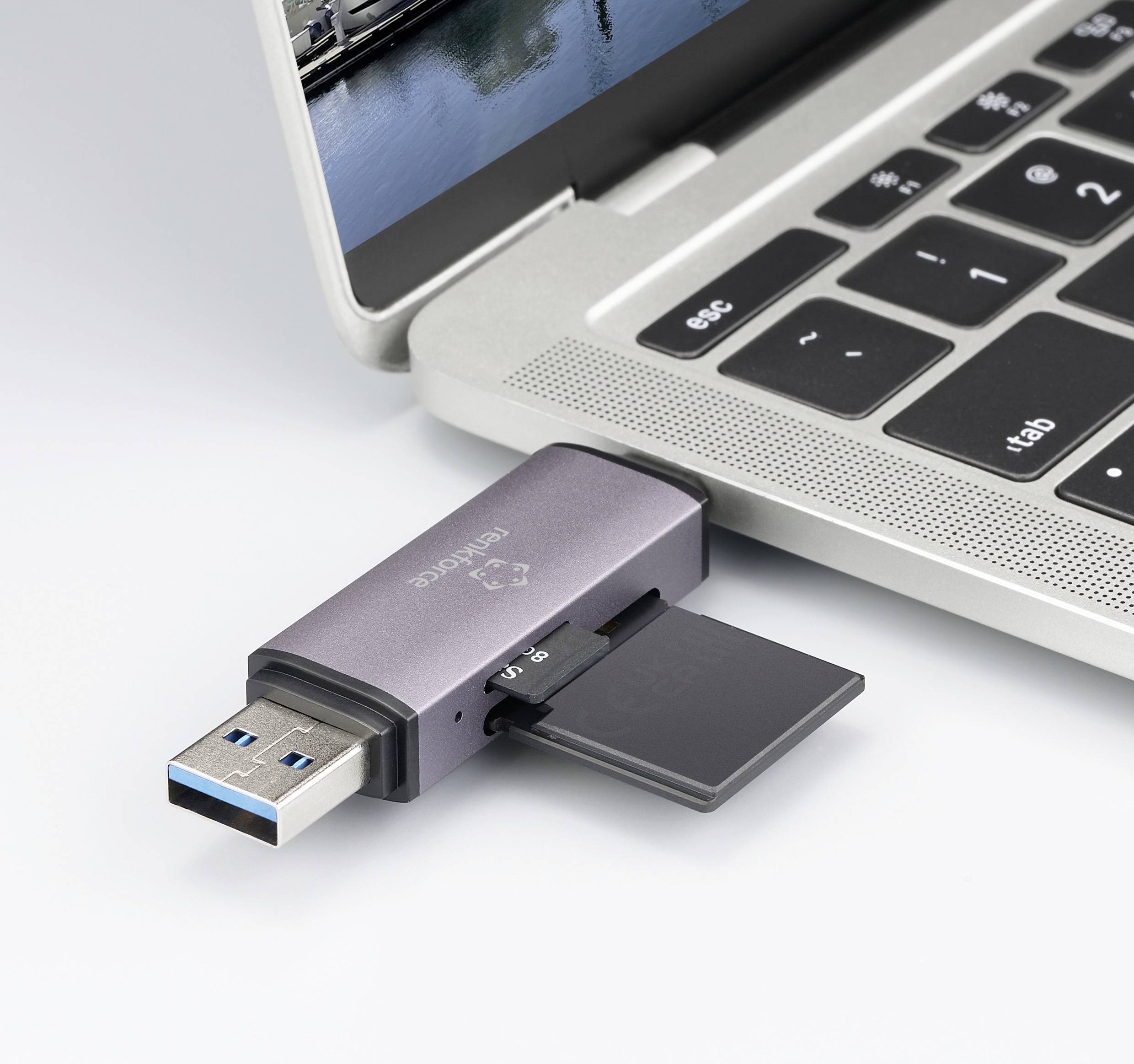 Prijenosno računalo s USB-ključem priključenim na ulaz. Na ključu se nalazi microSD kartica. Zaslon prikazuje nejasnu sliku.