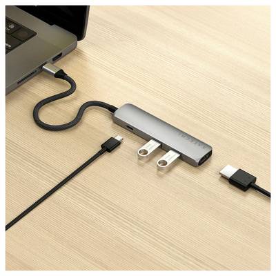 Prijenosno računalo spojeno je putem USB razvodnika s više priključaka. Na drvenom stolu vidljivi su USB i HDMI kabeli.
