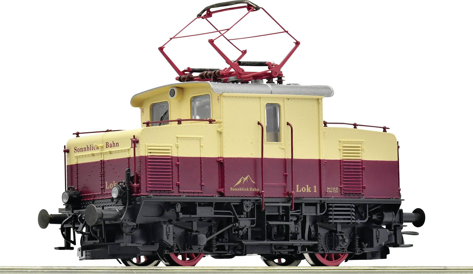 Mala modelska lokomotiva, bojana crveno-žuto, s natpisom 'Simmentalbahn'. Na krovu ima pantograf.