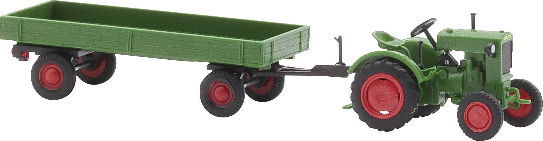 Igračka traktor sa zelenom prikolicom na crvenim kotačima.